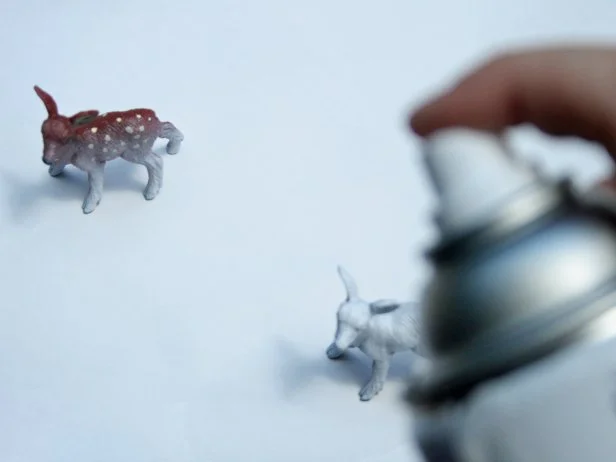 Spray priming deer figures