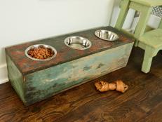 Create a custom feeding station that will make eating and drinking easier on your pet. Old wooden crates, boxes or stools can all be converted into a piece that's functional for your best friend and will look great in your home. <strong>Note:</strong> Some veterinarians warn that raised feeders may cause bloat  in large- and giant-breed dogs by allowing them to eat and drink too quickly causing their stomach to fill with air. So this project is not advised for dogs who are at risk for bloat. If in doubt, first check with your vet.