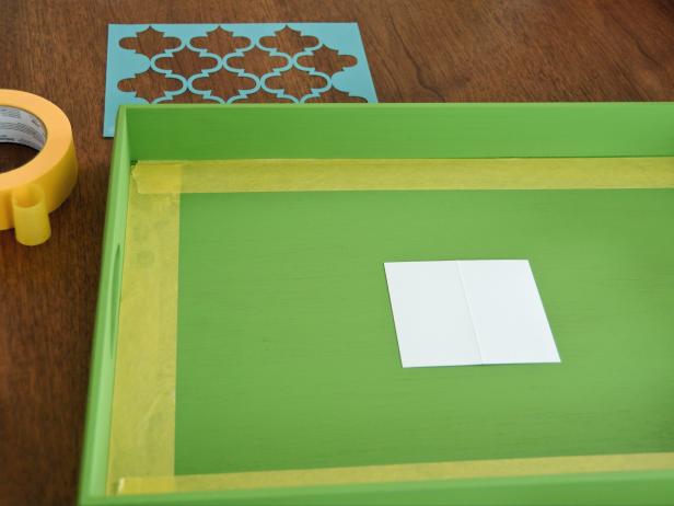 Tape off inside border of tray with painter's tape. Also tape off a square or rectangle in the tray's center for the monogram or use a piece of card stock or paper to mask it off. Make sure pieces of tape are firmly pressed down to avoid bleed under.