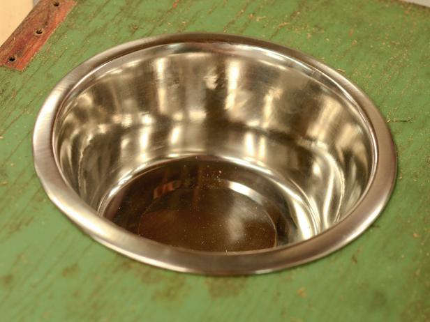 Drop food bowls inside holes to ensure a proper fit and reattach top to box or found object.