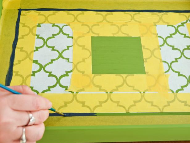 With a 1/2-inch flat brush, paint a border between taped lines.