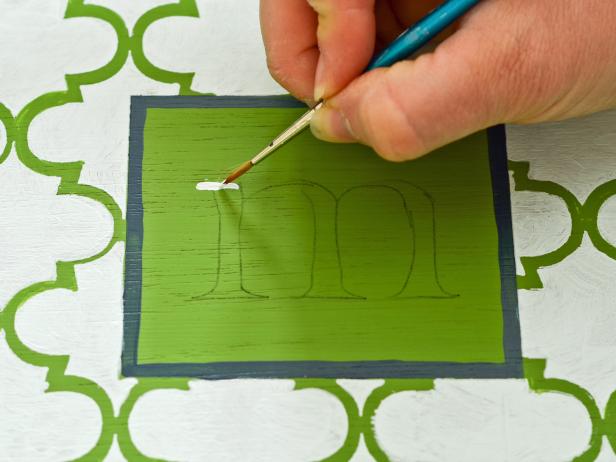 Paint lettering with a 1.0 liner brush; apply a second coat of paint if necessary.