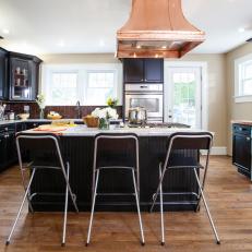 Transitional Kitchen With Black Island and Cabinetry