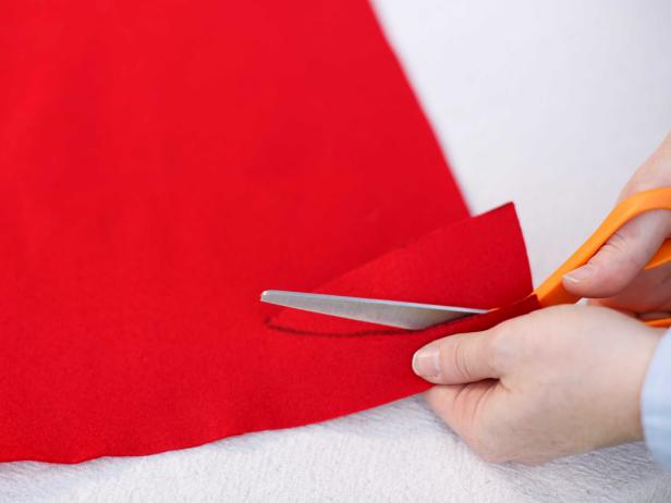 Using a stencil helps guide scissors when cutting out the design on this sheet of red felt.