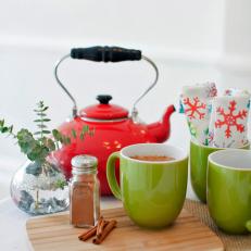Green Mugs With Cinnamon and Red Teakettle