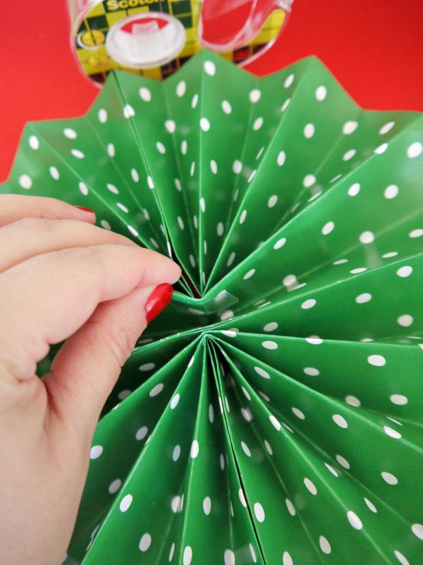Fold each sheet widthways, and secure with tape. Attach all three pieces together and secure the middle with double-sided tape.