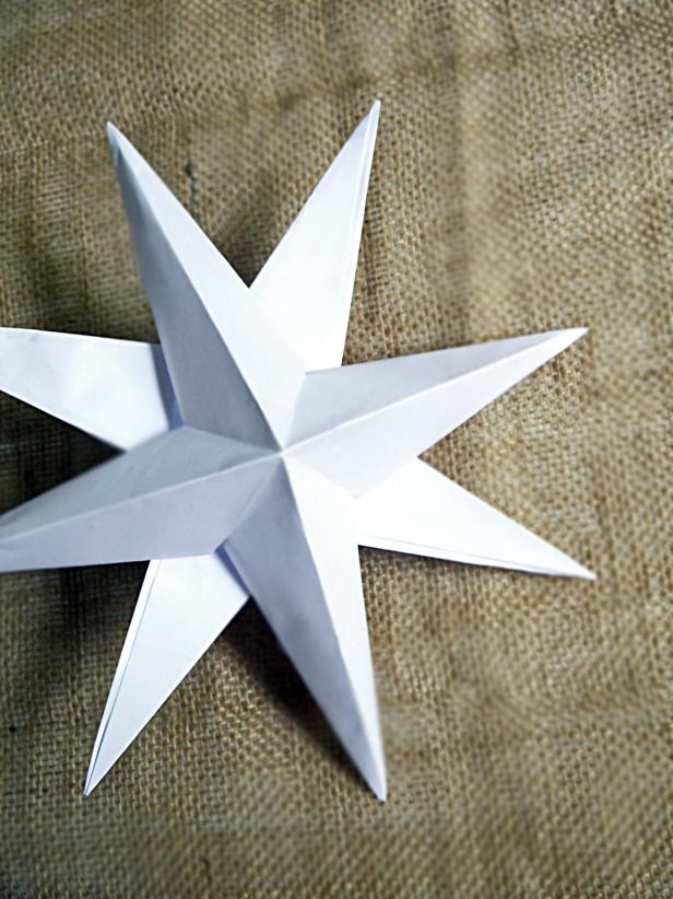 Repeat process with another sheet of white card stock. Let dry. Staggering the points of the stars, glue one star atop the other. Let dry before hanging. Hang stars on the wall in groupings for a stunning holiday display.