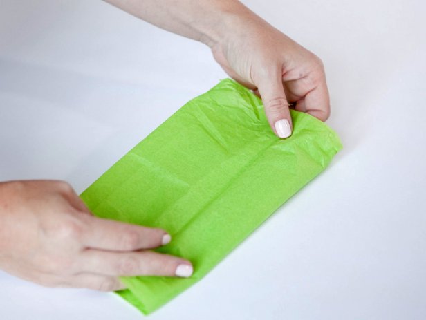 Fold tissue paper 4 times to create a beautiful and simple box for gift wrapping.