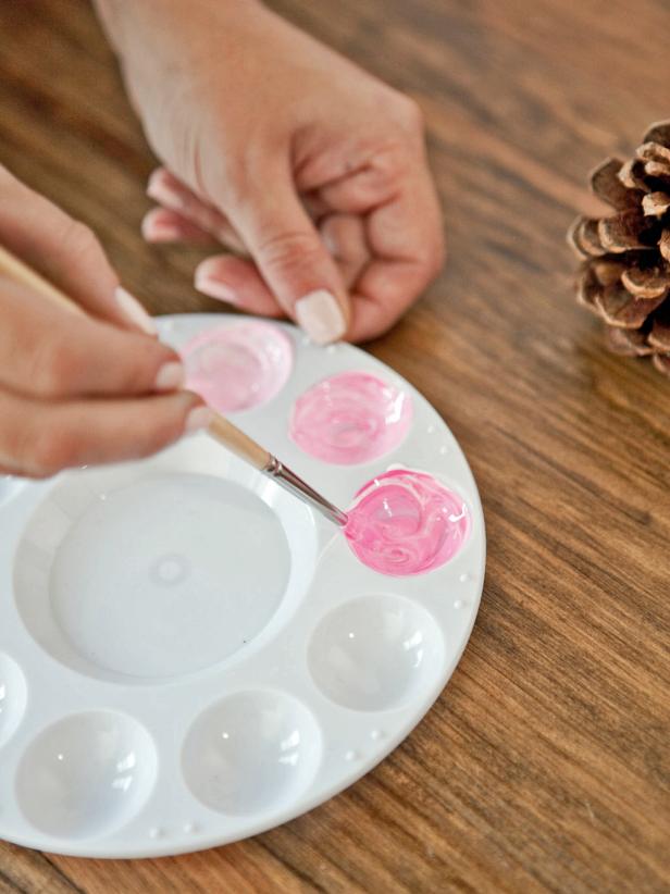 To create an ombre-painted pinecone, starting at the top of the pinecone with the lightest shade, paint the top few rows of petals. Paint the middle of the pinecone with the medium shade, and the bottom of the pinecone with the darkest shade.