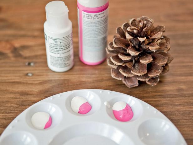 To create an ombre-painted pinecone, create three shades of a single paint color. To do this, squeeze colored paint into three spaces on the paint palette, cutting the amount in half each time. Then, add the opposite amount of white paint to all three spaces; the lightest color will have a tiny bit of color and a lot of white.