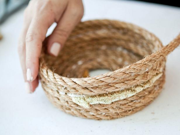When creating the sides of the basket, after two more rows of rope, add another section of gold ribbon. Add a few more rows of rope, a section of gold ribbon, and two more rows of rope. Keep adding rows of rope if you’d prefer a taller basket.