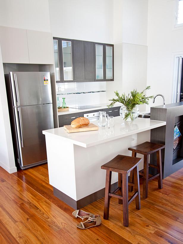 Modern White Kitchen With Warm Wood Floors | HGTV