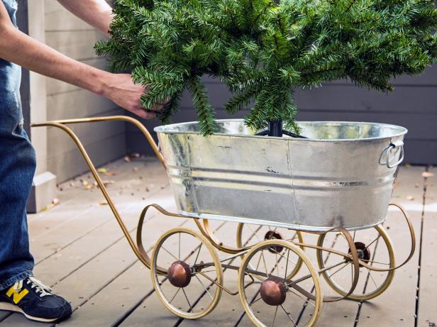 Green Tree Sits in Galvanized Metal Base With Wheels