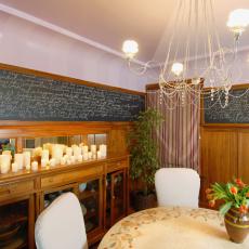 Dining Room With Elegant Chandelier and Chalkboard 