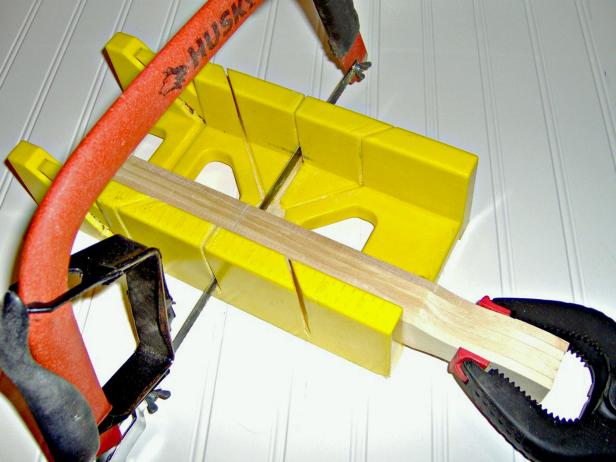 Cut the paint sticks with a band saw. If you don't have a band saw, you can use a jigsaw, or a miter box and hand saw.