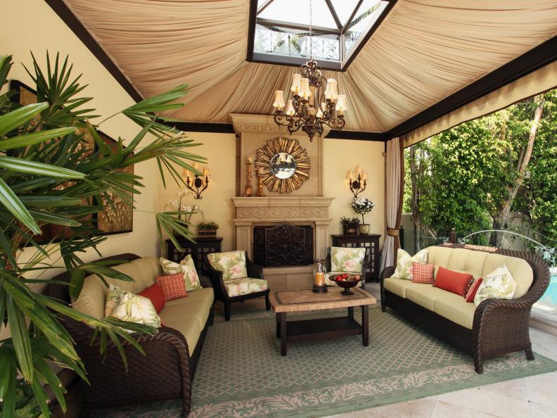 Outdoor Living Room With Fireplace and Chandelier 