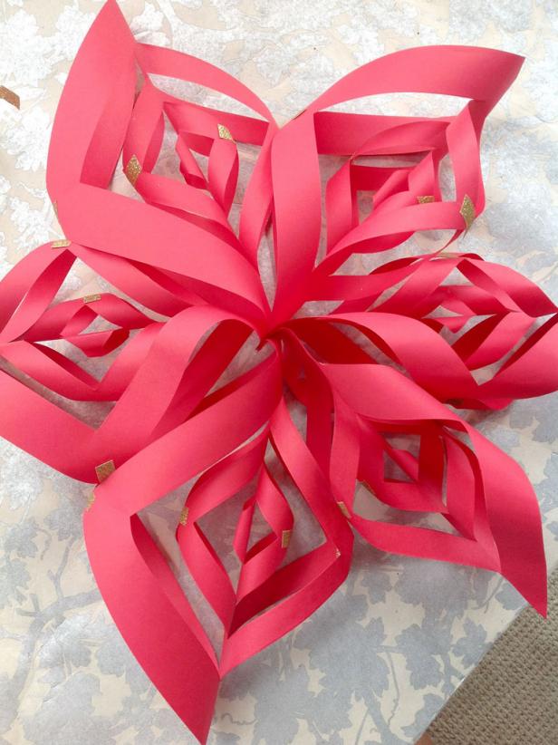 Small paper squares join in the center to create a snowflake with deceptively intricate points.