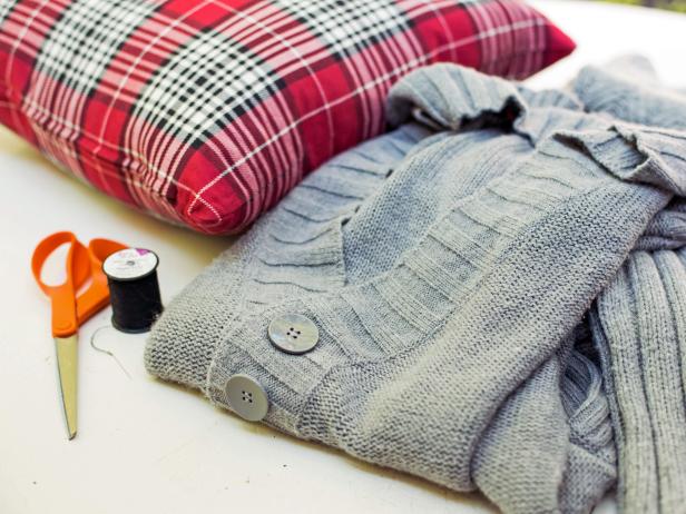 The first step in creating a sweater pillow is to gather the materials you will need to work on the project. You will need an needle and thread, a sweater or man's shirt, and pillow inserts.