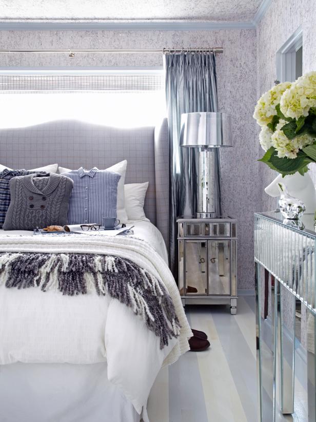 Bedroom With Gray Headboard, Mirrored Furniture and Menswear Pillows