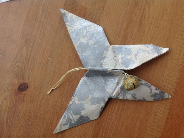 Your origami butterfly ornament is complete! Add beads, washi tape, or glitter to adorn if desired.