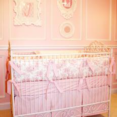 Pink Girl's Nursery With White Crib and Toile Fabric