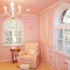 Pink Girl's Nursery With Toile Armchair and Wainscoting