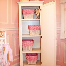 Pink Girl's Nursery With Wardrobe Storage Baskets