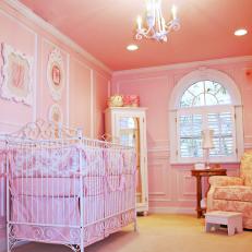 Pink Nursery With White Crib and Toile Fabric