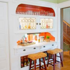 Contemporary Bar With Orange Shelving for Glasses