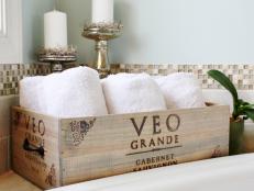 Wooden Wine Crate With Towels, Tile Border and Metallic Candlesticks