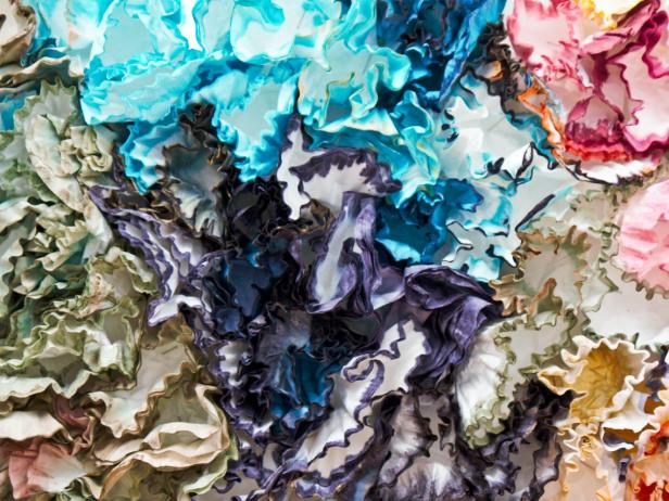For a more colorful backdrop, try dipping the tips of coffee filters into multi-hued fabric dyes, then affixing to a foam board for a floral effect. For a simpler backdrop, hang a section of Kraft paper and paint it with gold stripes or polka dots.