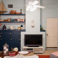 Nautical-Themed Blue Living Room With Navy Cabinet