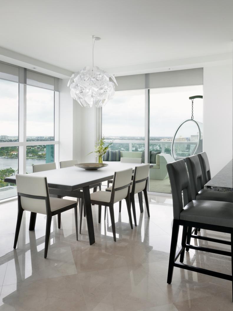 White Dining Room With Black Dining Table, Pendant and Bubble Chair