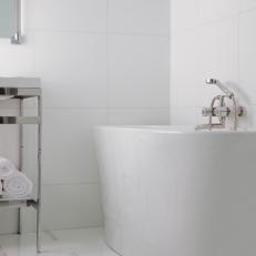 Sleek Freestanding Bath Tub in a White-and-Chrome Bathroom