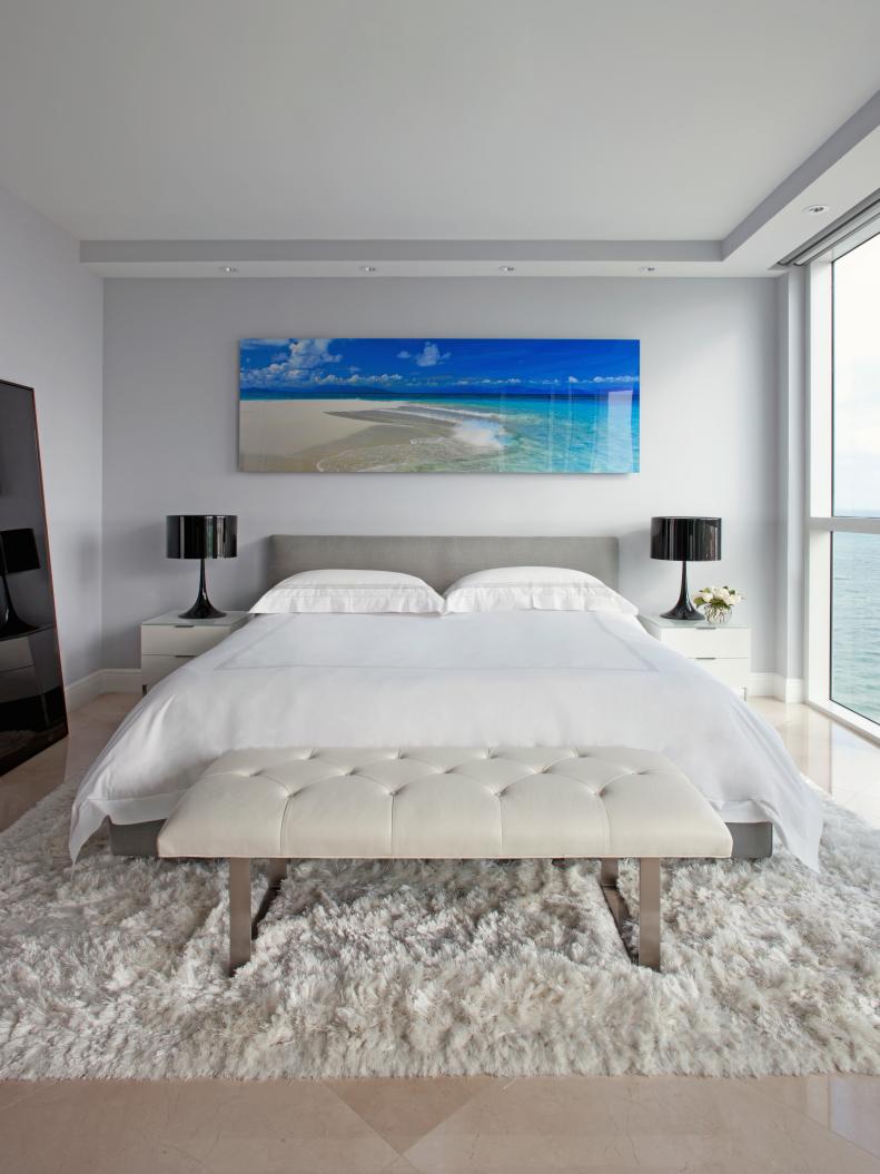 White Contemporary Bedroom With Large Beach Photograph and Black Lamps