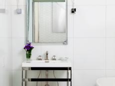 White Bathroom With Small Vanity and Rectagular Mirror