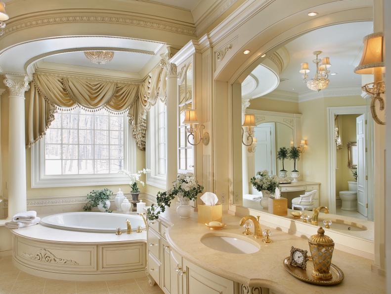 Ornate cream bathroom with large bathtub 