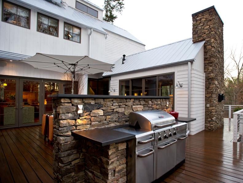 Wood Deck With Stainless Steel Grill, Stacked Stone Wall and Chimney