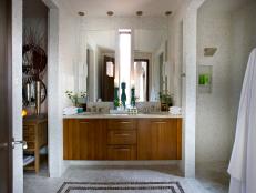 White Tile Bathroom With Wood Vanity, White Lights & Frameless Mirrors