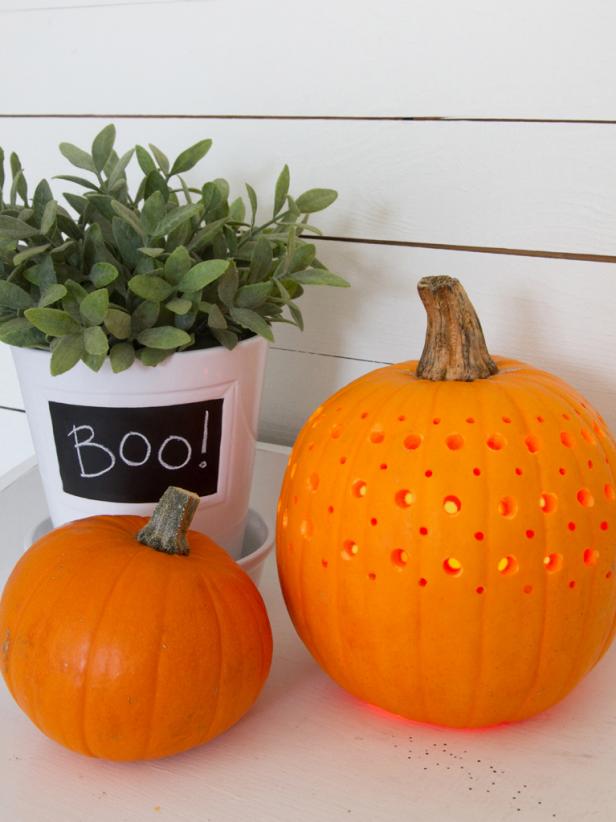 Candlelight shines through the pumpkin's holes.