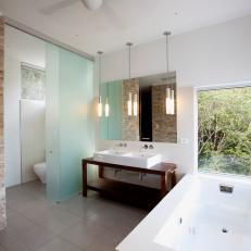 Frosted Glass Divider Provides Privacy in Open Bathroom