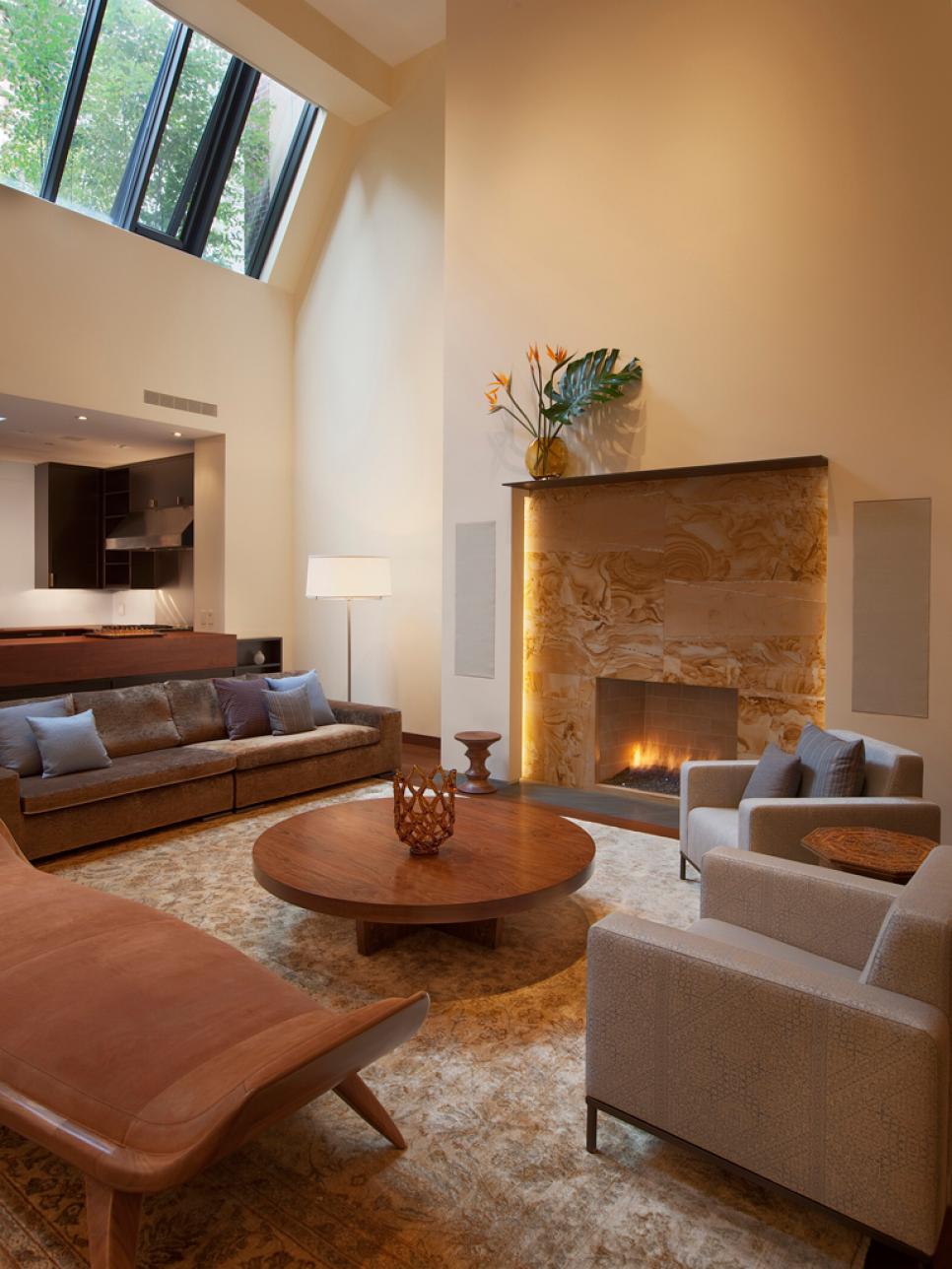Modern Living Room With Stone Fireplace and High Ceiling | HGTV
