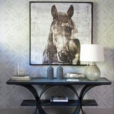 Horse Painting Hangs Over a Contemporary ConsoleTable