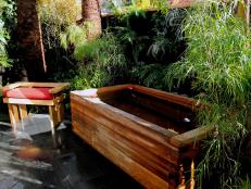 Outdoor Space With Dark Wood Tub and Adjacent Wood Chair