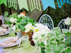 Blue and Green Bunting Above Outdoor Dining Table