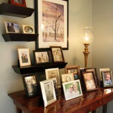 Framed Family Photos and Original Art on Bedroom Table