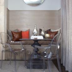 Neutral Seating Nook With Round Mirror and Acrylic Chairs