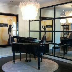 Black Grand Piano With Tile Mirrored Wall and Chandelier