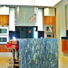 Neutral Modern Kitchen With Dark Granite Island and Double Ovens