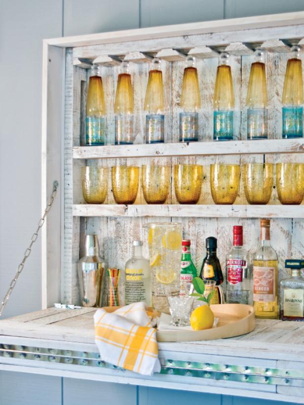 Decorate your bar with something functional. Colorful glasses double as a decoration and glassware for refreshments.